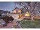 Two-story house with attached garage, landscaping, and large tree at night at 926 Highland Park Dr, Broomfield, CO 80020