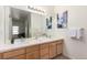 Double vanity bathroom with modern light fixtures and large mirror at 8200 E 8Th Ave # 8101, Denver, CO 80230
