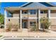 Inviting exterior of a two-story townhome with stone accents and a covered porch at 8200 E 8Th Ave # 8101, Denver, CO 80230