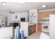 Open kitchen with breakfast bar overlooking living room at 8200 E 8Th Ave # 8101, Denver, CO 80230