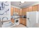 Modern kitchen featuring light wood cabinets and a white appliance package at 8200 E 8Th Ave # 8101, Denver, CO 80230