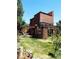Two-story home with wraparound deck, offering scenic views and ample outdoor space at 9655 Morrison Rd, Lakewood, CO 80227