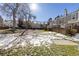 Community backyard with trees and patchy snow on the ground at 10852 Summerset Way, Parker, CO 80138