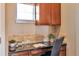 Functional home office with built-in cabinetry and granite countertop at 8537 E 35Th Ave, Denver, CO 80238