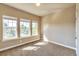 Well-lit bedroom featuring three windows and carpeted floors at 8537 E 35Th Ave, Denver, CO 80238