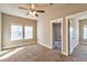 Spacious bedroom with carpet flooring, ceiling fan and access to another room at 8537 E 35Th Ave, Denver, CO 80238