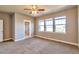 Spacious bedroom with ceiling fan, large windows, and access to bathroom at 8537 E 35Th Ave, Denver, CO 80238
