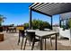 Community rooftop deck with pergola, tables, and chairs at 1601 Park Ave # 216, Denver, CO 80218
