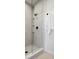 Clean shower with glass enclosure, tiled walls, and built-in shelves at 1601 Park Ave # 216, Denver, CO 80218