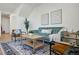 Relaxing living room with teal sofa and ample natural light at 1601 Park Ave # 216, Denver, CO 80218