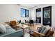 Bright and airy living room with light teal sofa and wood coffee table at 1601 Park Ave # 216, Denver, CO 80218
