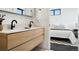 Contemporary bathroom with double sinks, a large mirror, and access to bedroom at 1601 Park Ave # 216, Denver, CO 80218