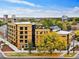 Modern building with wood siding, tree-lined street at 1601 Park Ave # 216, Denver, CO 80218