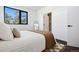 Bright bedroom with a cozy bed, large window, and ensuite bathroom access at 1601 Park Ave # 216, Denver, CO 80218