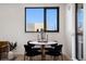 Small dining area with round table and four black chairs at 1601 Park Ave # 216, Denver, CO 80218