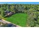 Large vacant lot surrounded by mature trees and homes at 755 S Jackson St, Denver, CO 80209
