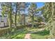Peaceful walkway winds through a lush green space with mature trees and a charming stone bench at 2227 Canyon Blvd # 253B, Boulder, CO 80302
