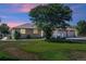 House exterior at dusk showcasing a three-car garage and a landscaped yard at 11685 Salem St, Henderson, CO 80640