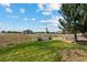 View of large backyard with detached garage and distant homes at 11685 Salem St, Henderson, CO 80640