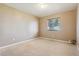 Simple, carpeted bedroom with large window at 11685 Salem St, Henderson, CO 80640