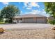 House exterior on a sunny day with a three-car garage and landscaped yard at 11685 Salem St, Henderson, CO 80640