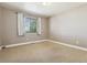 Spacious bedroom with neutral carpeting and large window at 11685 Salem St, Henderson, CO 80640
