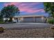 House exterior at dusk with three car garage and landscaped yard at 11685 Salem St, Henderson, CO 80640