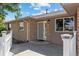 Brick front entry with a gray door and white picket fence at 11685 Salem St, Henderson, CO 80640