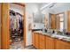 Bathroom with double sinks, granite countertop, and a walk-in closet at 36023 Winchester Rd, Elizabeth, CO 80107