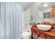 Bathroom with a vintage style vanity, white vessel sink and shower/tub at 36023 Winchester Rd, Elizabeth, CO 80107