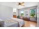 Main bedroom with hardwood floors, large windows, and a view of the backyard at 36023 Winchester Rd, Elizabeth, CO 80107