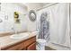 Clean bathroom with a shower/tub combo, a pedestal sink and a peacock-themed shower curtain at 13042 Grant E Cir # C, Thornton, CO 80241