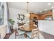 Open concept dining room with kitchen access, round table, four chairs and hardwood floors at 13042 Grant E Cir # C, Thornton, CO 80241