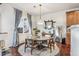 Elegant dining room features a round table, four chairs, hardwood floors and a statement mirror at 13042 Grant E Cir # C, Thornton, CO 80241