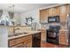 Modern kitchen with stainless steel appliances and wood cabinetry at 13042 Grant E Cir # C, Thornton, CO 80241
