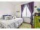 Spacious bedroom with a king-size bed, built-in shelving and large windows at 13042 Grant E Cir # C, Thornton, CO 80241