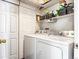 Laundry room with washer, dryer, and ample storage shelving at 13042 Grant E Cir # C, Thornton, CO 80241
