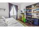 Bedroom with king bed, built-in workspace and colorful accents at 13042 Grant E Cir # C, Thornton, CO 80241