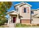 Two-story townhome with red door and brick accents, offering curb appeal at 13042 Grant E Cir # C, Thornton, CO 80241