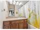 Bathroom with a single sink vanity, tub shower and an arched hallway view at 13042 Grant E Cir # C, Thornton, CO 80241