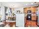 Modern kitchen with wood cabinets, brick backsplash, and stainless steel appliances at 13042 Grant E Cir # C, Thornton, CO 80241