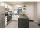 Modern kitchen with white cabinets, dark countertops, and stainless steel appliances at 7978 Chase Cir # E, Arvada, CO 80003