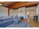 Gathering room with wood-beamed ceiling, white brick walls, and a fireplace at 2812 Krameria St, Denver, CO 80207