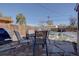 Stone patio with seating area and grill; fenced backyard with some snow at 2812 Krameria St, Denver, CO 80207