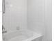 Bathroom with a white bathtub and tiled walls at 5726 N Genoa Way # 10-106, Aurora, CO 80019