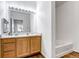 Bathroom with a vanity, mirror, and a bathtub at 5726 N Genoa Way # 10-106, Aurora, CO 80019