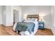 Bedroom with a full bed, wood floors, and access to a closet at 5726 N Genoa Way # 10-106, Aurora, CO 80019