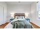 Bedroom with a full bed, wood floors, and window access at 5726 N Genoa Way # 10-106, Aurora, CO 80019