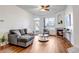 Bright living room with fireplace, wood floors, and access to a patio at 5726 N Genoa Way # 10-106, Aurora, CO 80019