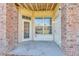 Ground-level patio with brick walls and door access at 5726 N Genoa Way # 10-106, Aurora, CO 80019